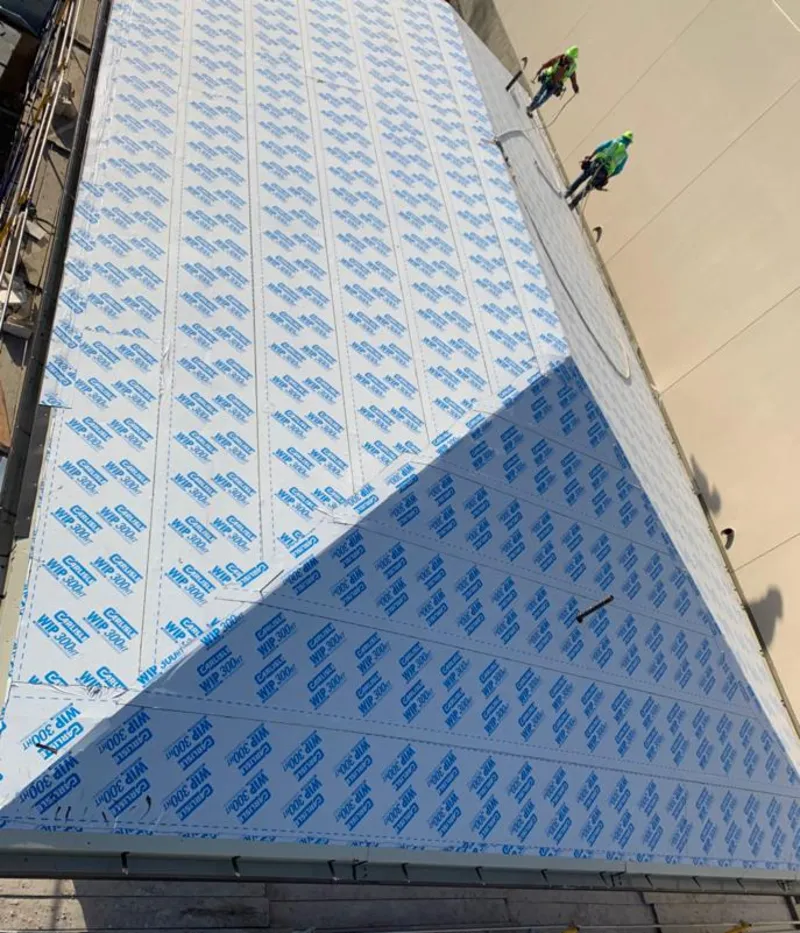 Professional roofers installing underlayment on a metal roof in Lake Havasu City